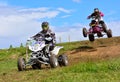 Unidentified racers rides a quad motorbike.