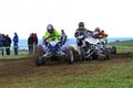 Unidentified racers rides a quad motorbike.