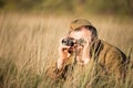 Unidentified re-enactor dressed as Soviet soldier looks at an old army