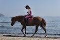 Unidentified rider on a horse on the beach. Horseback riding in Crete one of the favorite pastimes of vacationers