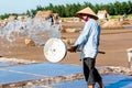 An unidentified salt worker splashing water cleaning fields in Hai Hau dist., Namdinh, Vietnam