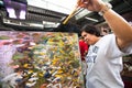 Unidentified seller in fishmarket at Chatuchak Weekend Market in Bangkok, Thailand.