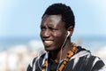 Unidentified Senegalese man listens to music and smiles on the