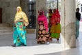 Unidentified Senegalese people in traditional clothes walk in t