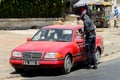 Unidentified Senegalese policeman talks to the driver of the re