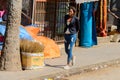 Unidentified Senegalese woman puts her hands behind her back at