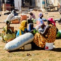 Unidentified Senegalese women pack vegetables in the bags.