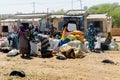 Unidentified Senegalese women pack vegetables in the bags.