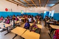 Unidentified serious and sad african children sitting at desks in a classroom in a primary school. New class with new desks, roof Royalty Free Stock Photo