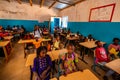 Unidentified serious and sad african children sitting at desks in a classroom in a primary school. New class with new desks, roof Royalty Free Stock Photo