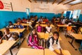 Unidentified serious and sad african children sitting at desks in a classroom in a primary school. New class with new desks, roof