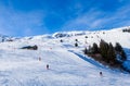 Unidentified skiers enjoy skiing at the slope in the Alps