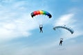 Unidentified skydivers on blue sky Royalty Free Stock Photo