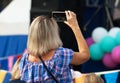 Unidentified spectator filming a concert