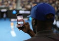 Unidentified spectator uses his cell phone to take images during tennis match at 2019 Australian Open in Melbourne Park Royalty Free Stock Photo