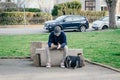 Unidentified teenager playing online game on mobile phone or smartphone on the bench. Gadget addiction concept