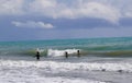 Unidentified three children enjoying wavy Mediterranean