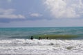 Unidentified three children enjoying wavy Mediterranean