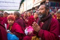 Unidentified tibetan Buddhist monks near stupa Boudhanath during festive Puja.