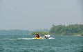 Unidentified tourist enjoying a Banana ride at Tarkarli beach. The beach is famous for various water sports activities Royalty Free Stock Photo