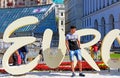 Unidentified tourist near part of official logo of Eurovision Song Contest 2017 on Maidan Nezalezhnosti Independence Square Royalty Free Stock Photo