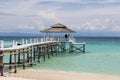 Unidentified tourist taking picture at wooden jetty at Mantanani Island