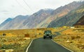 Unidentified tourist vehicles on Mountain road of Ladakh, Northern India. Beautiful landscape of Ladakh, highest plateau in India