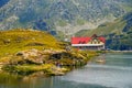 Unidentified tourists enjoy the sights of Balea Lake at 2,034 m altitude in Fagaras Mountains Royalty Free Stock Photo