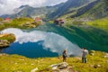 Unidentified tourists enjoy the sights of Balea Lake at 2,034 m altitude in Fagaras Mountains Royalty Free Stock Photo