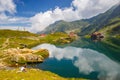 Unidentified tourists enjoy the sights of Balea Lake at 2,034 m altitude in Fagaras Mountains Royalty Free Stock Photo