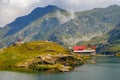 Unidentified tourists enjoy the sights of Balea Lake at 2,034 m altitude in Fagaras Mountains Royalty Free Stock Photo