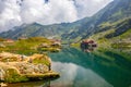 Unidentified tourists enjoy the sights of Balea Lake at 2,034 m altitude in Fagaras Mountains Royalty Free Stock Photo