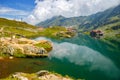 Unidentified tourists enjoy the sights of Balea Lake at 2,034 m altitude in Fagaras Mountains Royalty Free Stock Photo