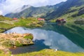 Unidentified tourists enjoy the sights of Balea Lake at 2,034 m altitude Royalty Free Stock Photo