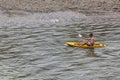 Unidentified tourists are rowing kayak boats in Song River.