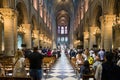 Unidentified tourists visiting the Notre Dame de Paris in Paris, France. The cathedral of Notre Dame is one of the top tourist