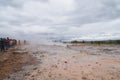 Unidentified tourists waitng for eruption of Strokkur Geysir,Iceland. Royalty Free Stock Photo