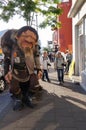 Unidentified tourists walking near Icelandic trolls on streets o