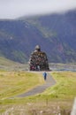 Unidentified tourists walking near Statue of Bardur Snaefellsnes,Iceland.