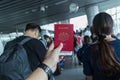 Unidentified traveler hand holding Malaysia international passport