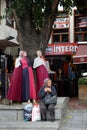 An unidentified Turkish woman sits outside a store on a street in Istanbul