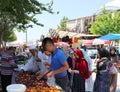 Unidentified Uzbek and Afghan people buying fruits at the Farmers Market