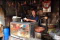 Vendor sits in his small shop