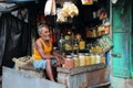 Vendor sits in his small shop