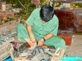 Unidentified vietnamese makes shoes from old truck tires in Cu C