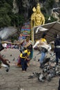 Unidentified visitors playing with pigeons outside the Batu Caves Temple  Malaysia Royalty Free Stock Photo