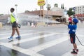 Unidentified volunteer boy throwing water in a runner