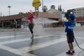 Unidentified volunteer boy throwing water in a runner