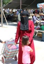 Unidentified Woman with Burka shopping at the farmers market