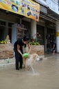 Unidentified woman dog bathing in flooding at Sriracha city after rainning